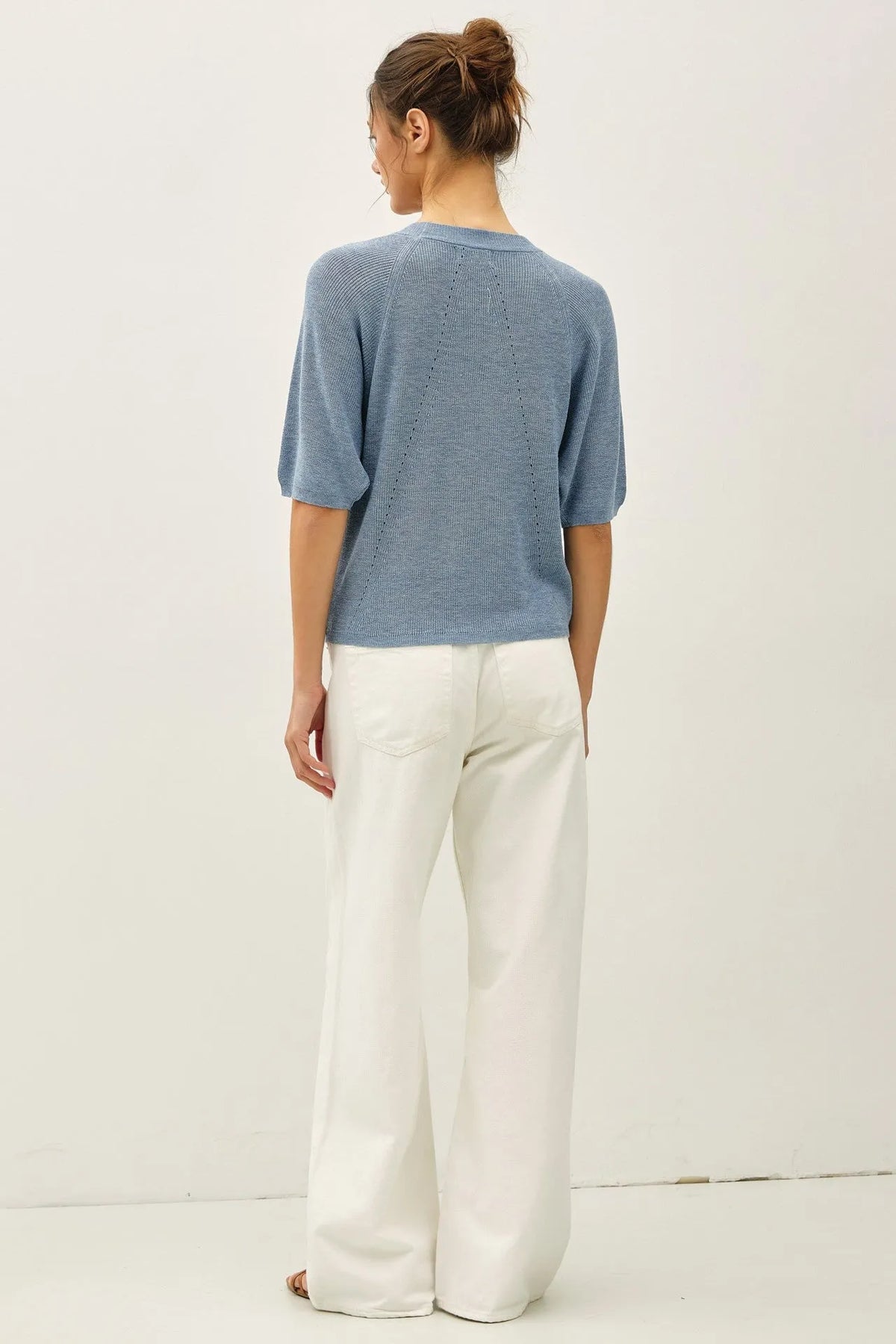Light blue lightweight ribbed knit raglan short sleeve top shown from the back with textured geometric pattern