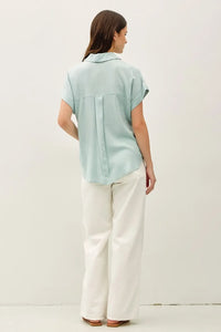 Light blue solid short sleeve button down shirt with collar and back seam detail showing the back side