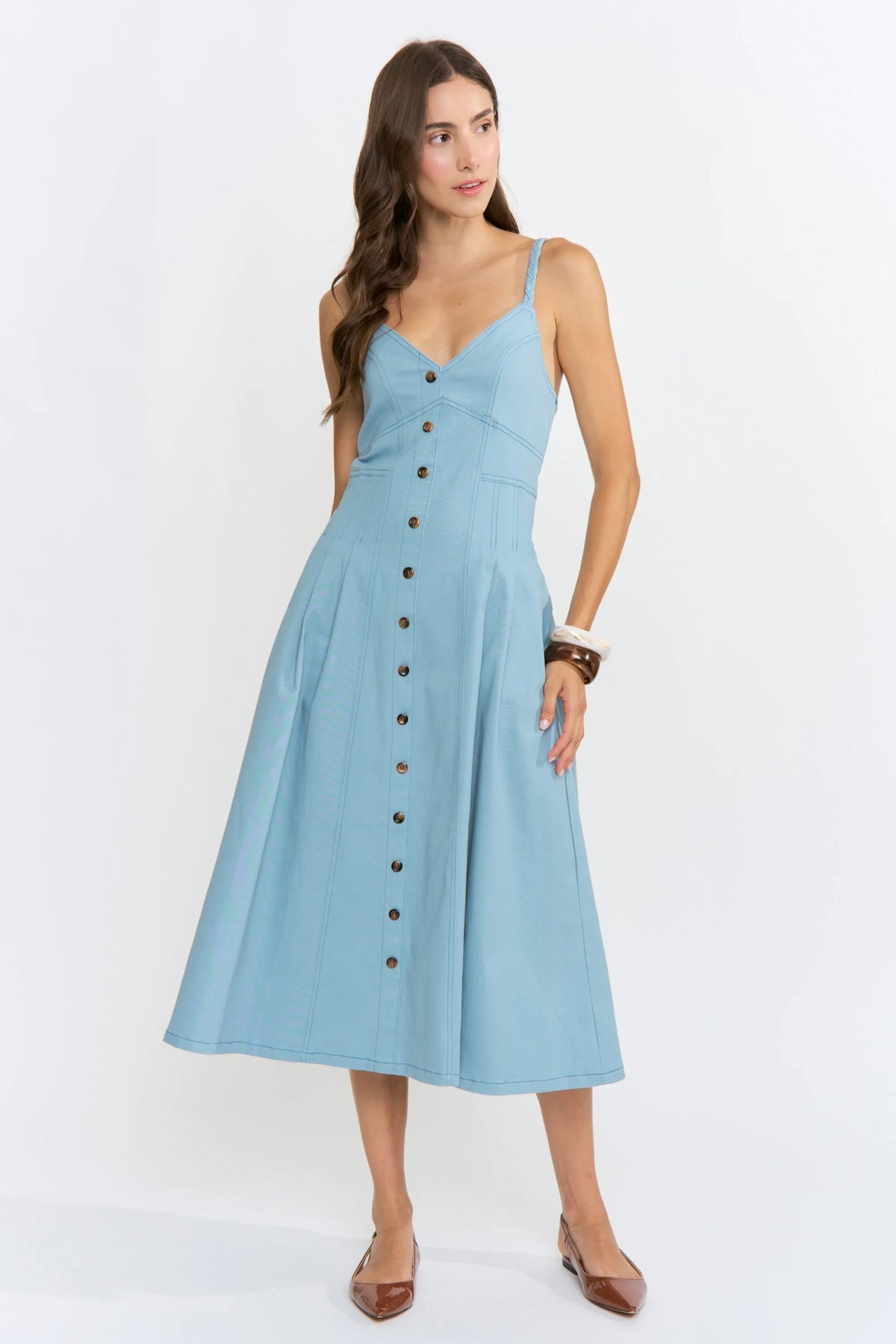 A light blue sleeveless midi denim dress with a button-front and thin straps perfect for casual wear