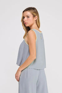 Light blue embroidered linen sleeveless top with delicate yellow lace trim along neckline and armholes