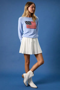 Light blue round neck flag print sweater top with embroidered American flag on the chest