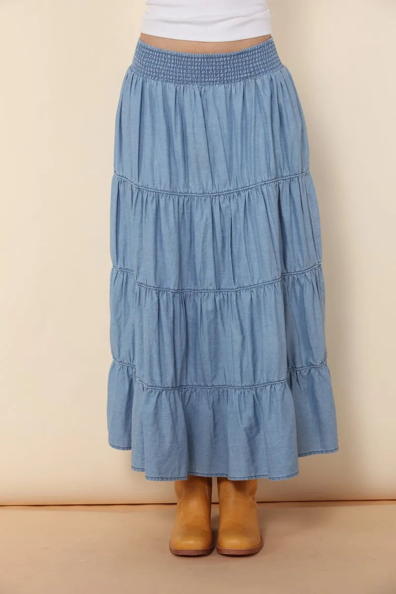 A light blue elastic tiered midi denim skirt with a smocked waistband and ruffled layers for a stylish look