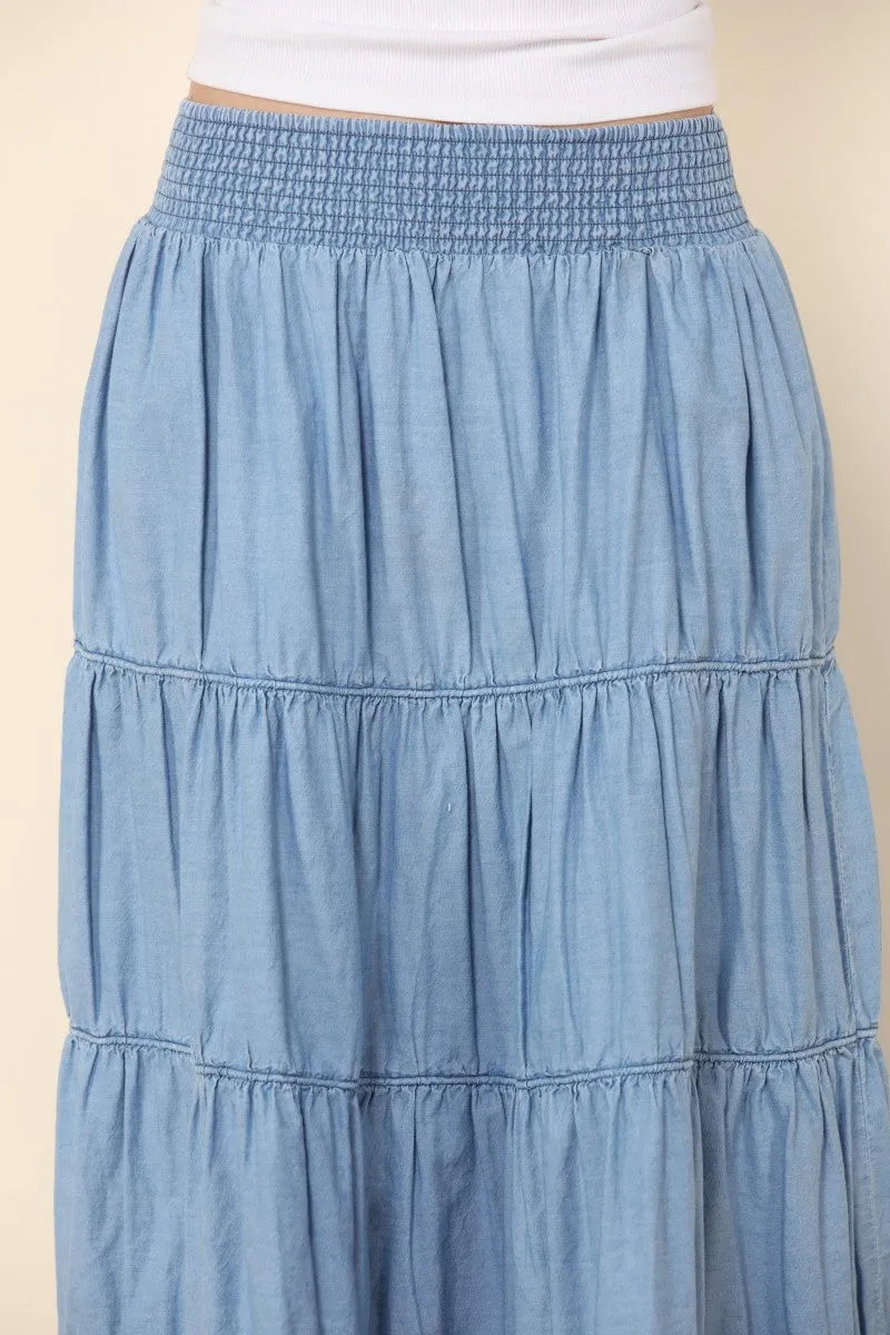 A light blue elastic tiered midi denim skirt with a stretchy waistband made of soft fabric