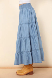 A light blue elastic tiered midi denim skirt with a smocked waistband for stylish casual wear