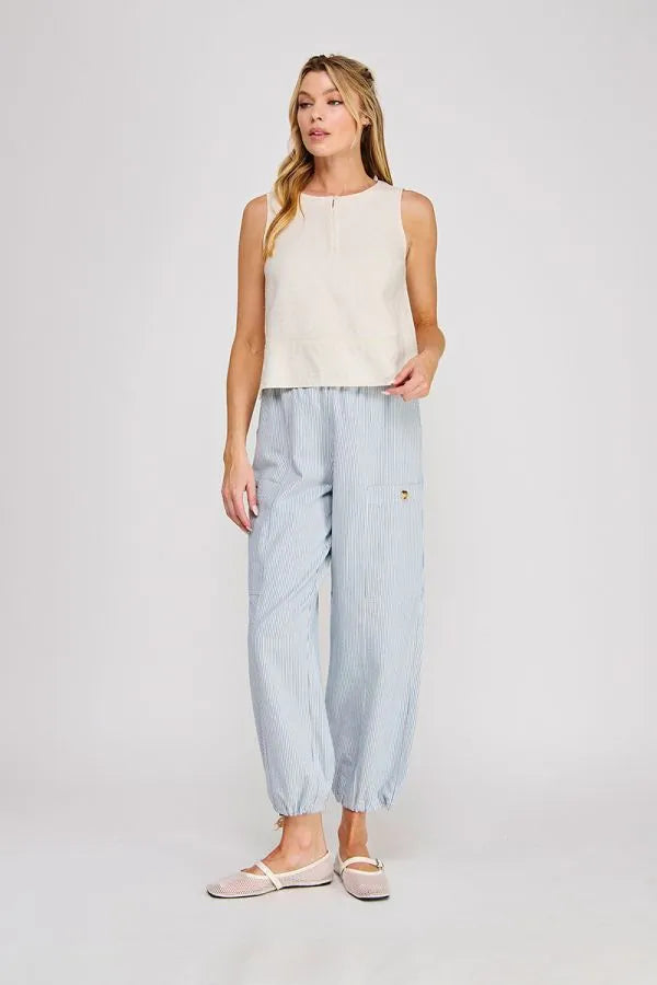 Light blue vertically striped cotton trousers with relaxed tapered fit paired with linen button collar textured top