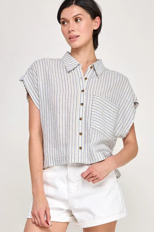 A light blue and white cap sleeve striped button down shirt with frayed sleeve hems and a front pocket