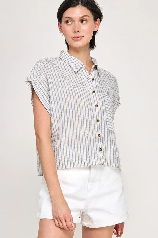 A light blue and white cap sleeve striped button short-sleeved shirt with collar and brown buttons down the front