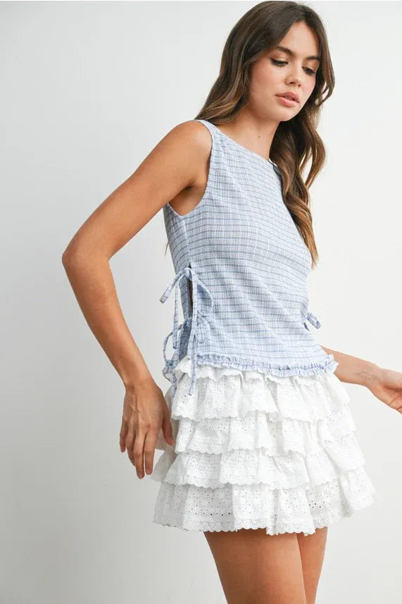 A light blue and white checkered ladder lace sleeveless top with ruffled side ties for casual wear