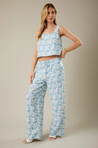 A light blue and white abstract print two-piece outfit with elastic waist tie pants and a square-neck crop top