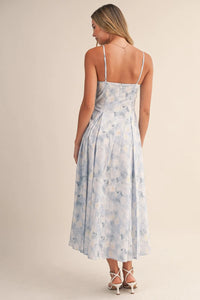 A flowing light blue and white floral bustier sleeveless flare midi dress with thin spaghetti straps