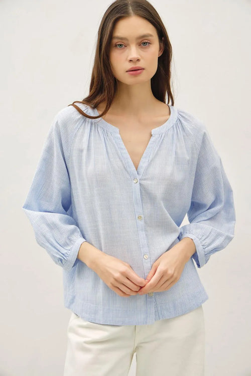 Light blue and white cotton round neck blouse with buff sleeve button front closure and puffed sleeves