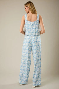 Light blue and white sleeveless square neck jumpsuit with abstract print for stylish summer wear