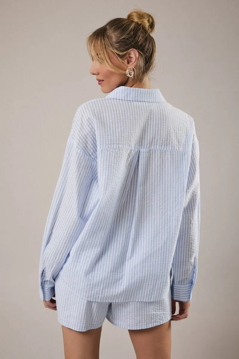 Light blue and white vertically striped loose-fitting button-up stripe shirt with lobster embroidery for women’s boho chic clothing