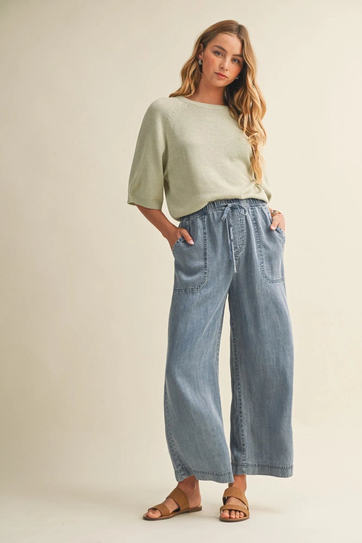 Light blue wide-leg denim pants with a drawstring waist and waist patch pocket for casual wear