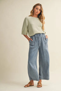 Light blue wide-leg denim pants with a drawstring waist and waist patch pocket for casual wear