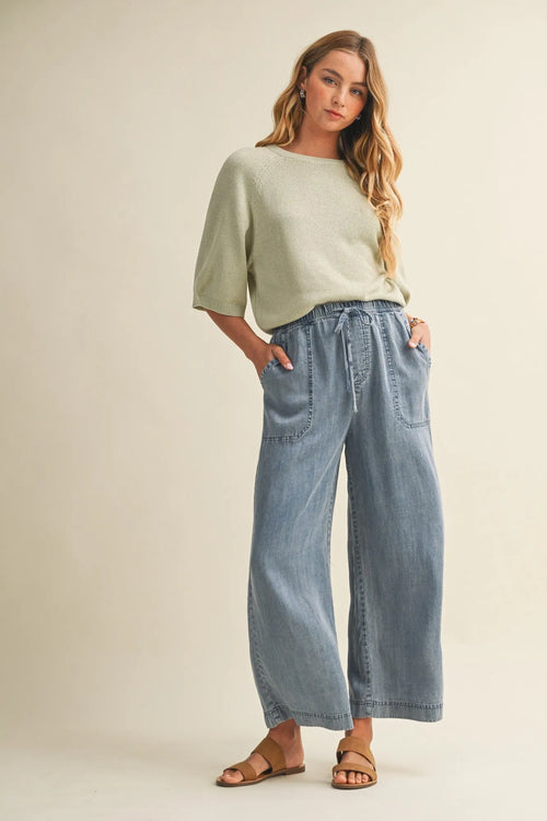 Light blue wide-leg denim pants with a drawstring waist and waist patch pocket for casual wear