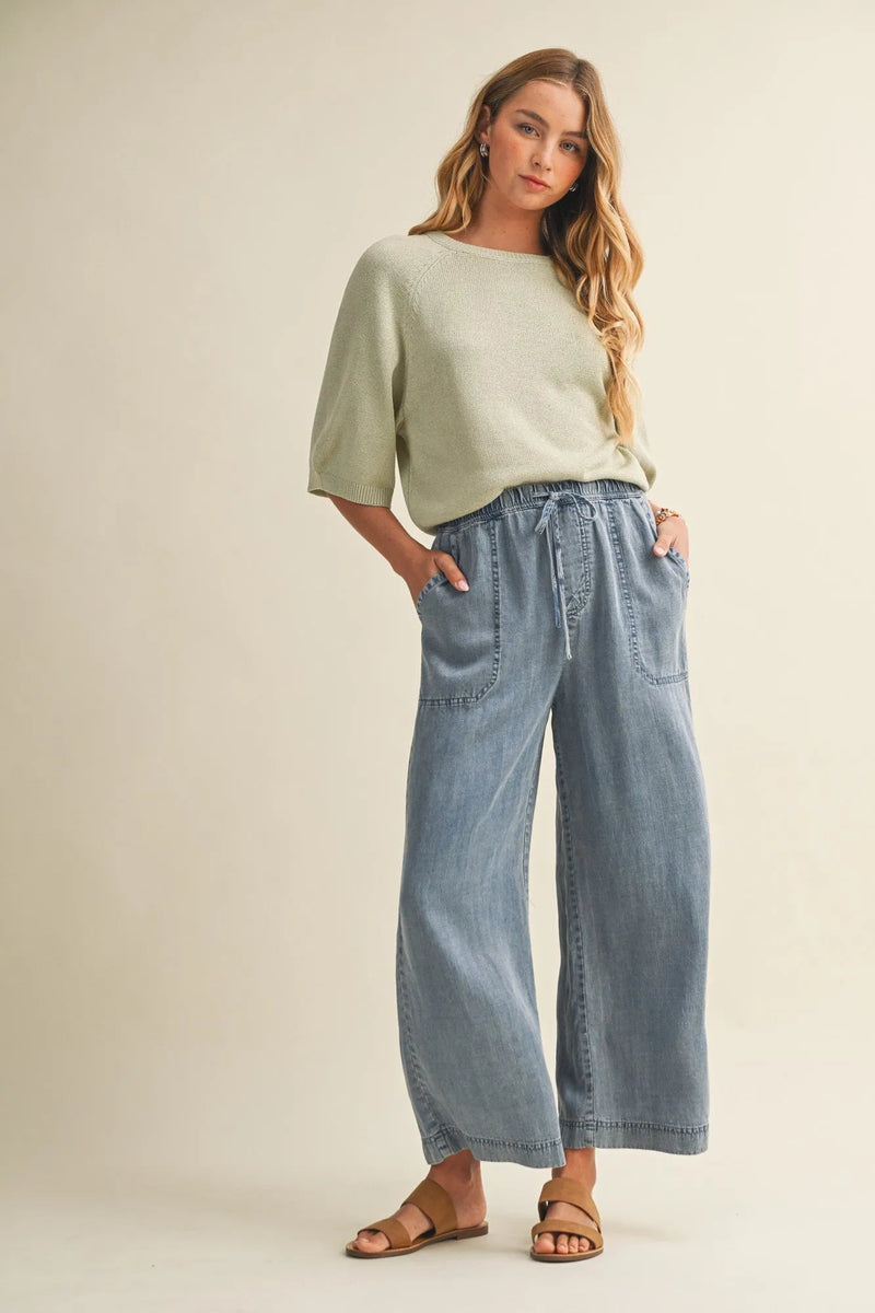 Light blue wide-leg denim pants with a drawstring waist and waist patch pocket for casual wear