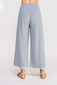 Light blue linen wide leg pants with elastic tie waist and scalloped hem detail for comfortable style