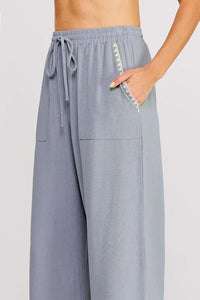 Light blue linen elastic tie waist wide leg pants with elastic waistband and decorative zigzag stitch on side pocket