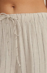 Light gray linen henri striped wide leg pants with thin black vertical stripes and matching drawstring waistband
