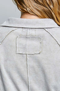 Back view of a light gray waffle knit slim fit boho deep v collar neck button jacket with a stitched patch pocket