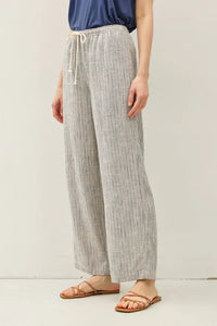 Light gray and white stripy linen wide leg pants with elastic waistband and matching drawstring pull on style