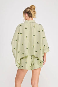 Light green palm tree crinkled woven blouse made of linen with subtle palm tree print perfect for casual wear