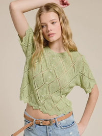 Light green pointelle knit short sleeve crop top with diamond lace pattern and scalloped hem in soft knit fabric