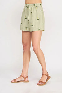 Light green palm tree crinkled woven shorts with a subtle palm tree print and elastic waistband for comfort
