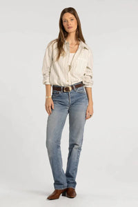 Light-wash blue denim jeans with classic straight-leg cut and brown leather belt buckle styled with thread & supply lexington shirt