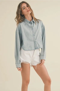 Light-wash denim shirt with a relaxed cropped fit and frayed hem for a casual short body denim style