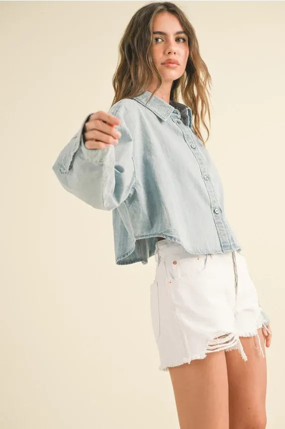 Light-wash denim short body denim shirt with button-front and rolled cuffs in a cropped design