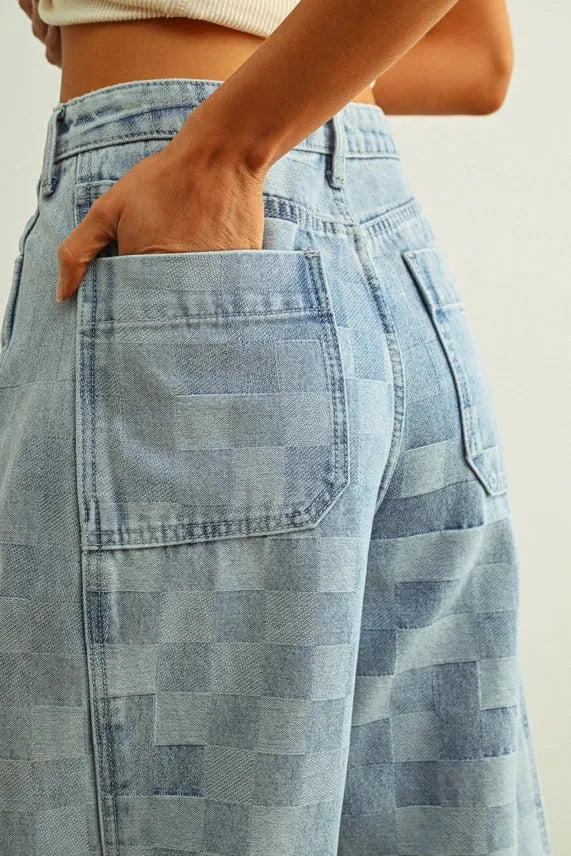 Light-wash denim high-rise wide-leg pants with a checker board pattern featuring woven patchwork design