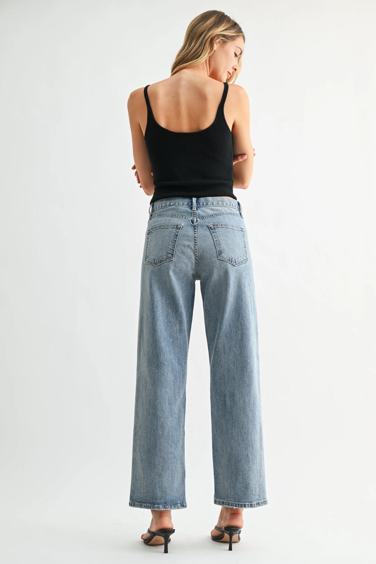 Back view of light-wash denim high-rise wide-leg jeans with classic pocket design from rise jb collection selvage jeans denim