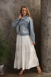 Oversized trucker bow patch denim jacket in light wash with a decorative bow patch on the front pocket
