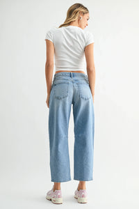 Back side of mid rise utility seamed barrel jean in light-wash denim with relaxed wide-leg cut and classic pockets