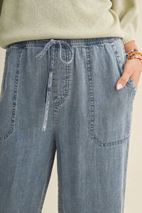 Light-wash denim drawstring waist patch wide leg pants with front waist patch pockets and a comfortable fit