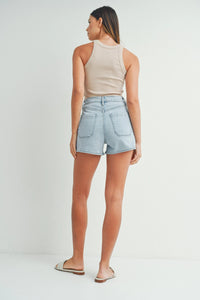 High rise patch pocket light-wash denim shorts shown from the back with classic pockets and a high-rise waist