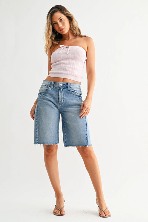 Back view of The Seamed Mid-Rise Longer Denim Short with frayed hem