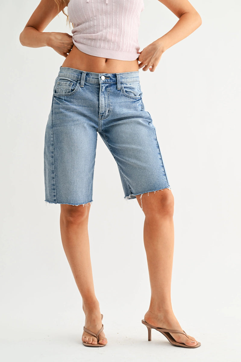 Back view of The Seamed Mid-Rise longer denim short with frayed hem