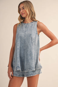 Light-wash denim longline sleeveless top with relaxed tiered hem and subtle stitching details