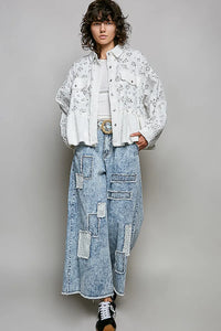 Light-wash denim wide-leg pants with patchwork detailing and frayed hems paired with floral ruffle detailing shacket