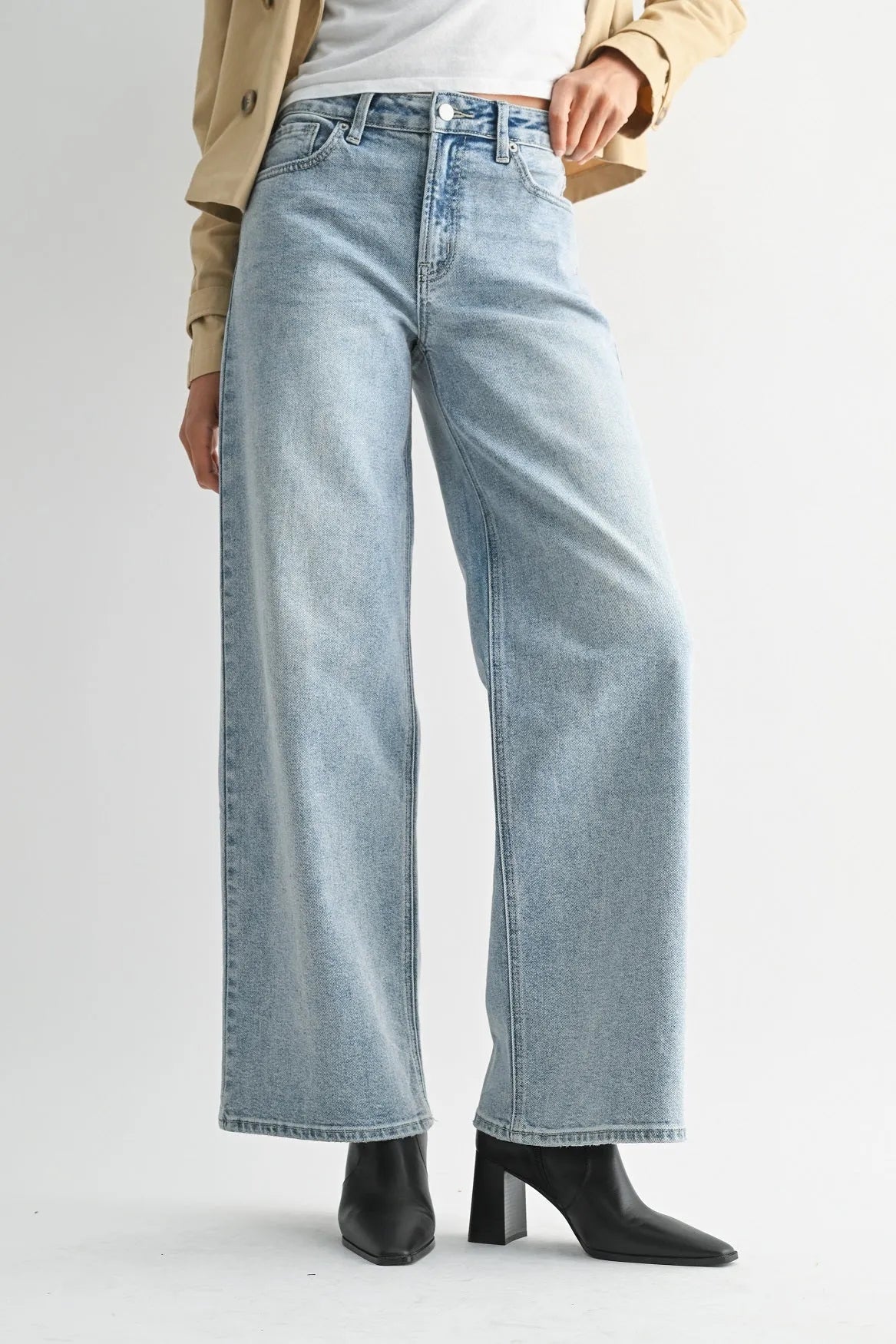 Light-wash high rise full length straight denim jeans featuring wide-leg fit, button fly, and classic five-pocket design
