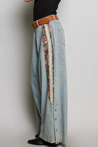 Relaxed fit pointed denim light-wash wide-leg pants with floral stripe and white piping in women’s boho chic clothing