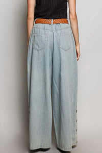 Light-wash relaxed fit pointed denim wide-leg pants with button side details and braided brown belt for women’s boho chic clothing