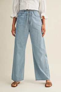 Light-wash relaxed denim pants with a drawstring waist in wide-leg style for casual comfort