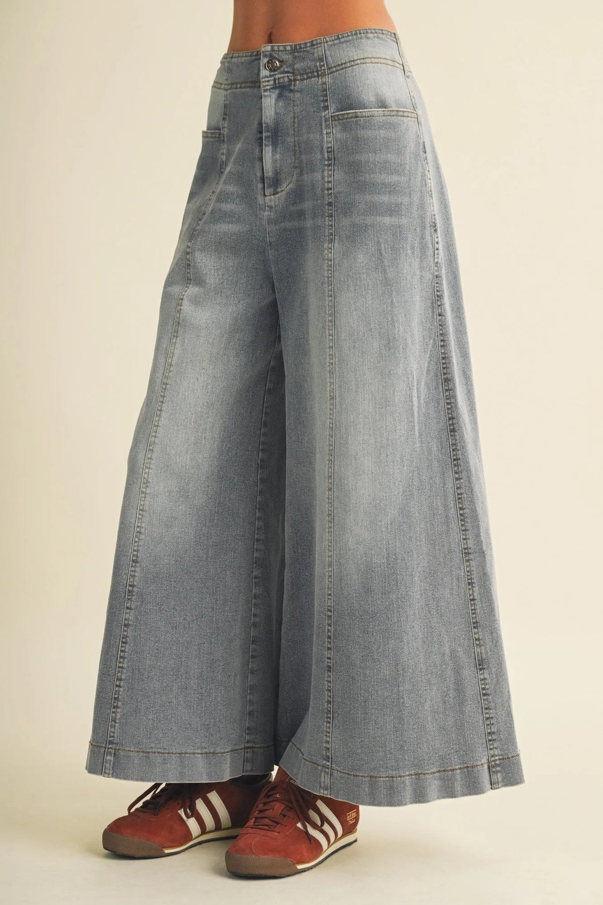 Light-wash denim vertical seam wide leg pants with a high waist and classic stitching in wide leg denim style