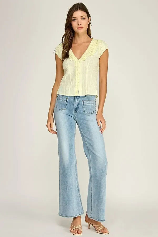 Light yellow lace-trimmed ruffle trim v-neck blouse with short sleeves and button-up front in soft fabric