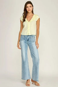 Light yellow lace-trimmed ruffle trim v-neck blouse with short sleeves and button-up front in soft fabric