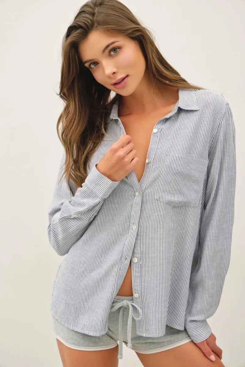 A loose-fitting linen blended stripe boxy shirt in soft gray and white vertical stripes with long sleeves and buttons